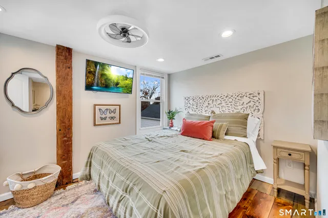 a bedroom with a large bed and a chandelier