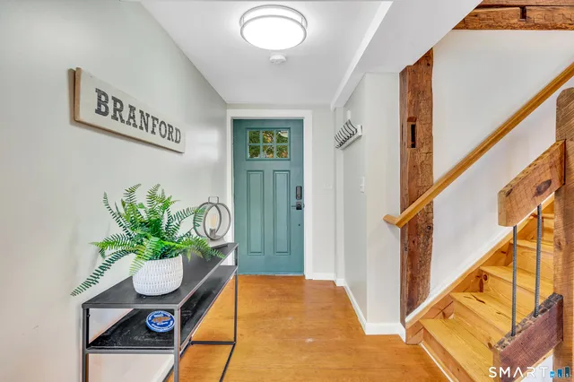 a kitchen with granite countertop a refrigerator stove and wooden floor