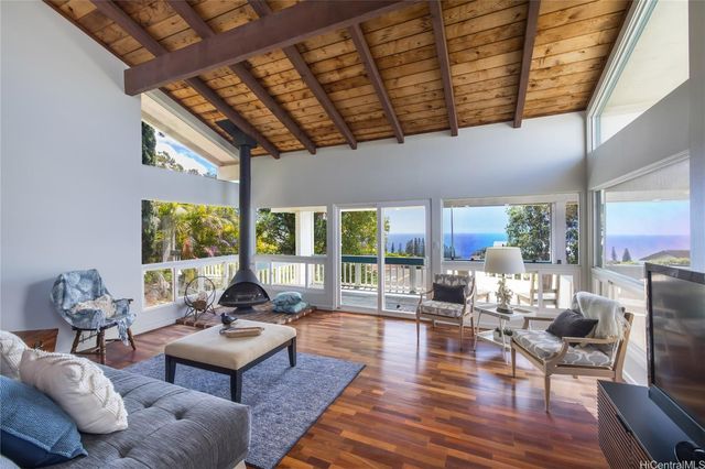 a living room with fireplace furniture and a wooden floor