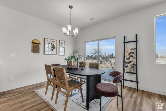 155 East 360th Street East, Unit 10B Fillmore, UT 84631 - Photo 14 of 43 Dining space with hardwood / wood-style floors and an inviting chandelier
