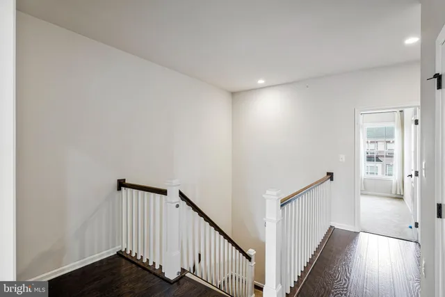 a view of a hallway with wooden floor