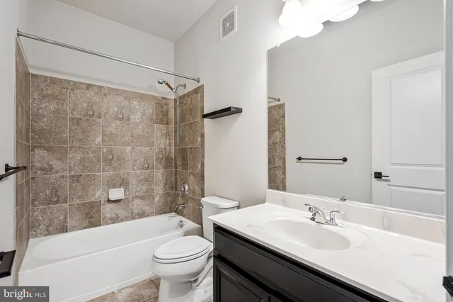 a bathroom with a double vanity sink toilet and shower