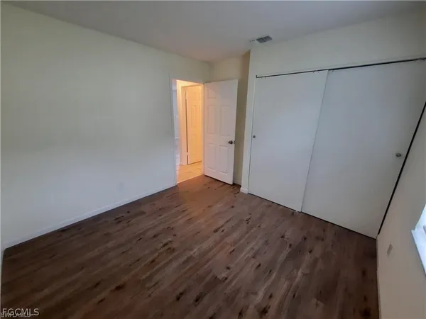 a view of a room with wooden floor