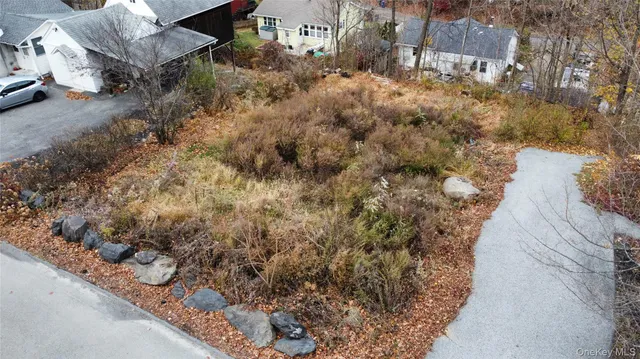a view of a yard with wooden fence