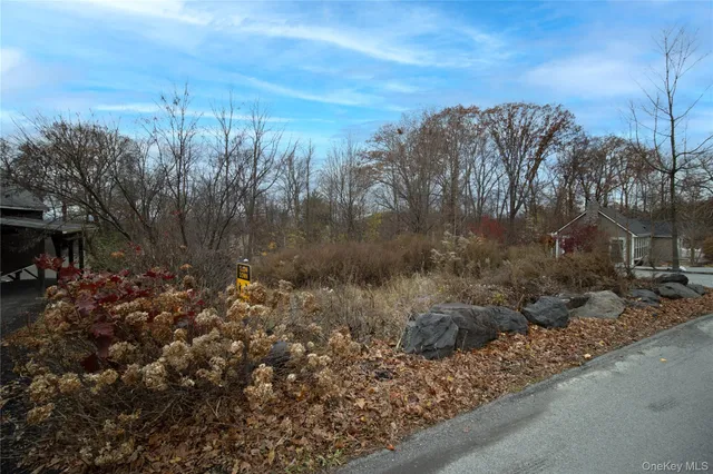 a view of a yard with wooden fence