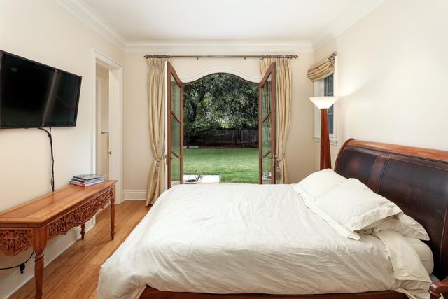 a bedroom with a bed and flat tv screen