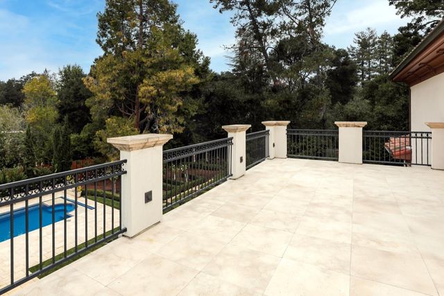 a view of a chair and trees in the background