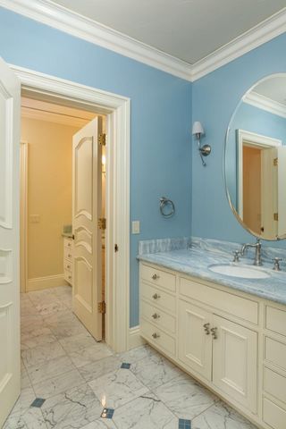 a bathroom with a granite countertop sink a mirror and a