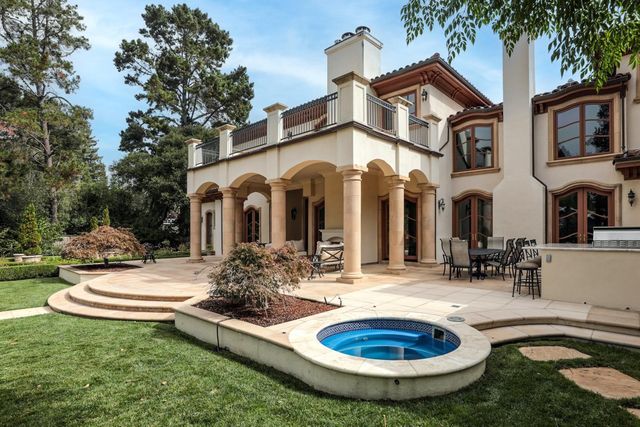 a view of a house with swimming pool and sitting area
