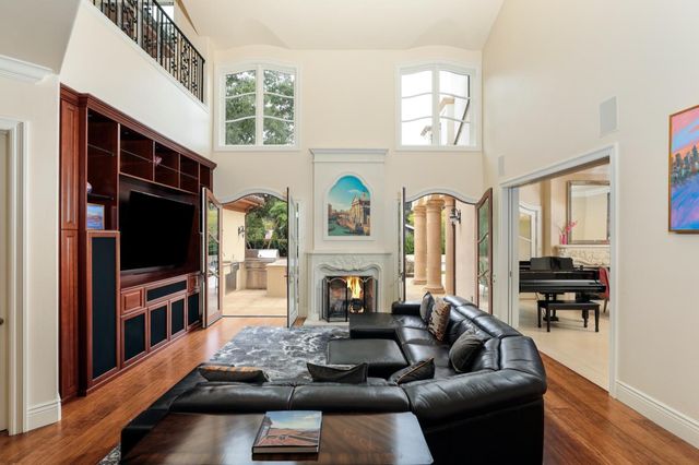 a living room with fireplace furniture and a flat screen tv