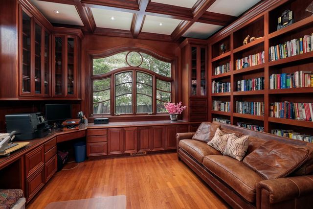 a living room with furniture and a book shelf