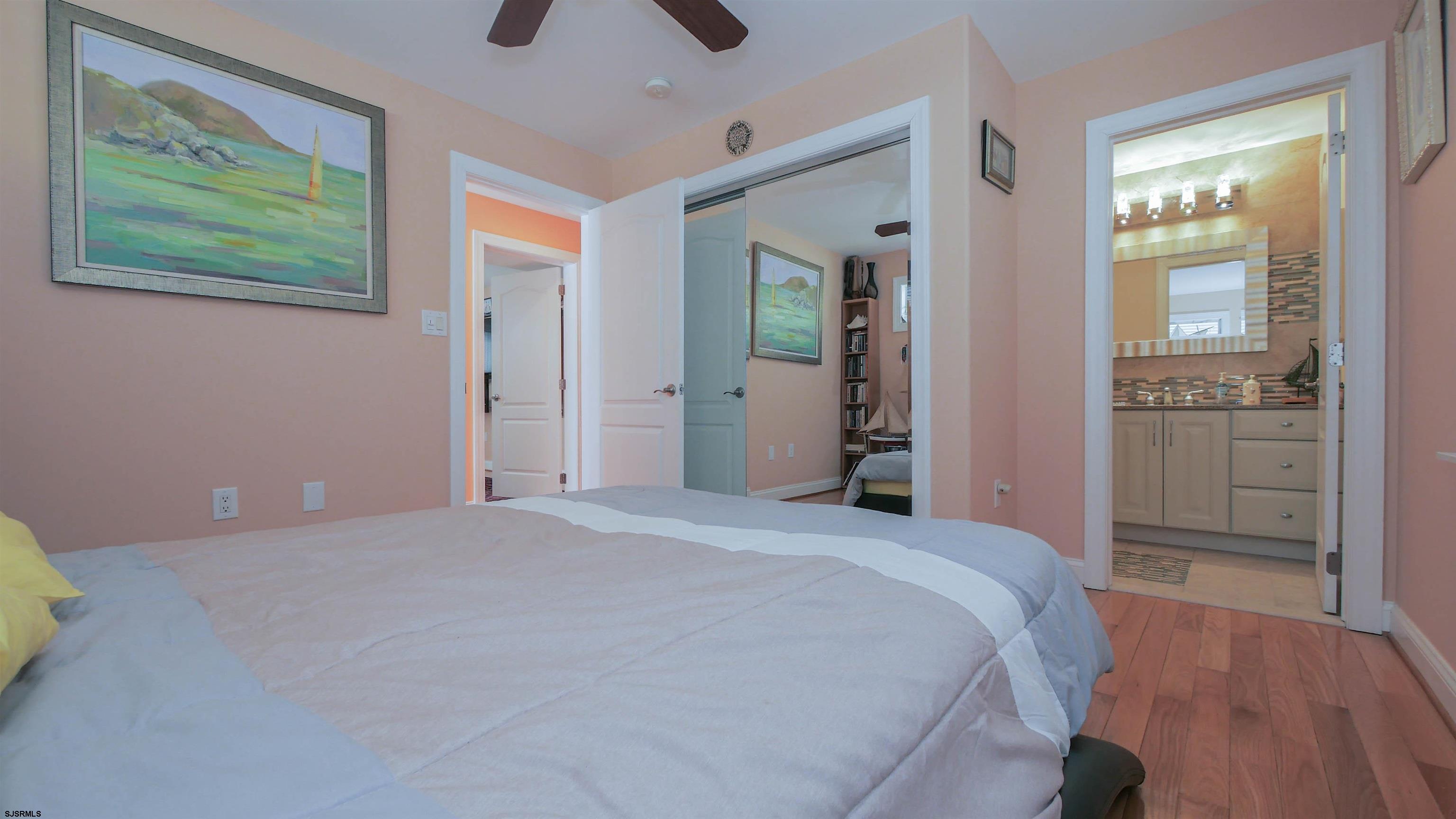 229 8th Street North Brigantine, NJ 08203 - Photo 19 of 42 a spacious bedroom with a bed and a view of bathroom