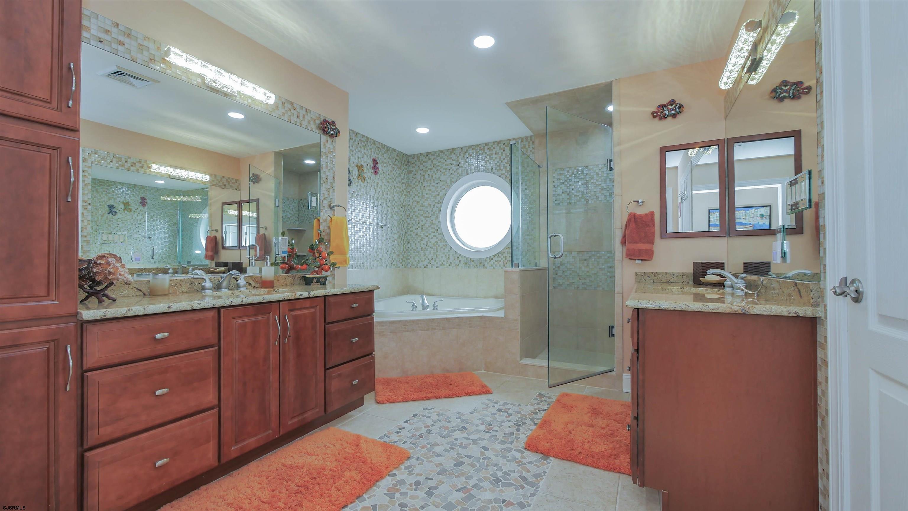 229 8th Street North Brigantine, NJ 08203 - Photo 24 of 42 a spacious bathroom with a granite countertop sink and a mirror