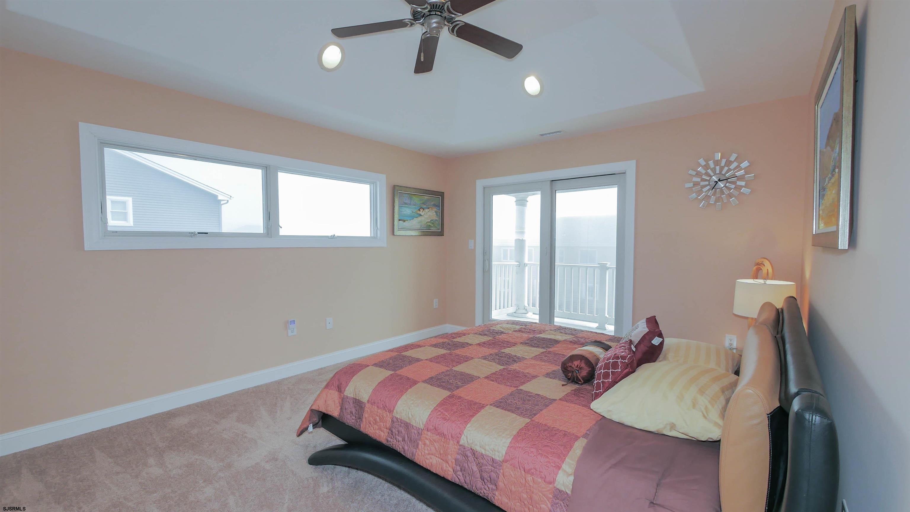 229 8th Street North Brigantine, NJ 08203 - Photo 29 of 42 a bedroom with a bed and window