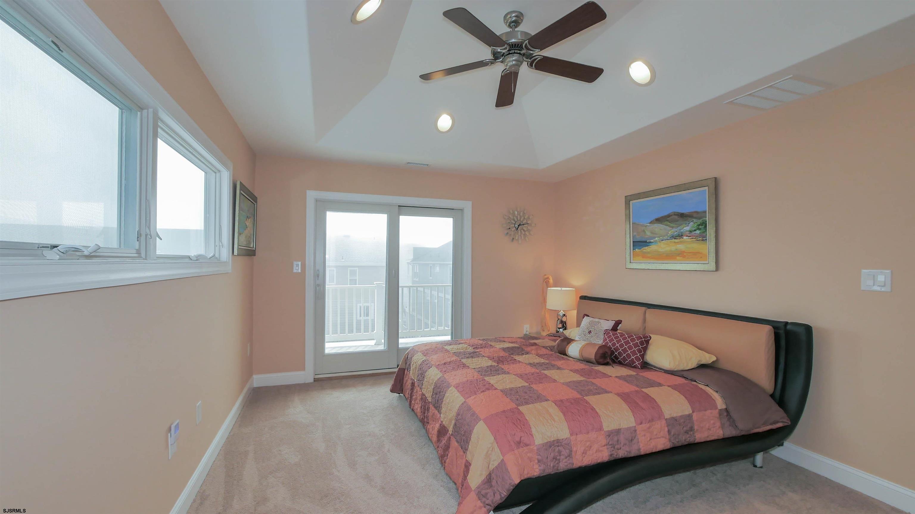 229 8th Street North Brigantine, NJ 08203 - Photo 30 of 42 a bedroom with a large bed and a window