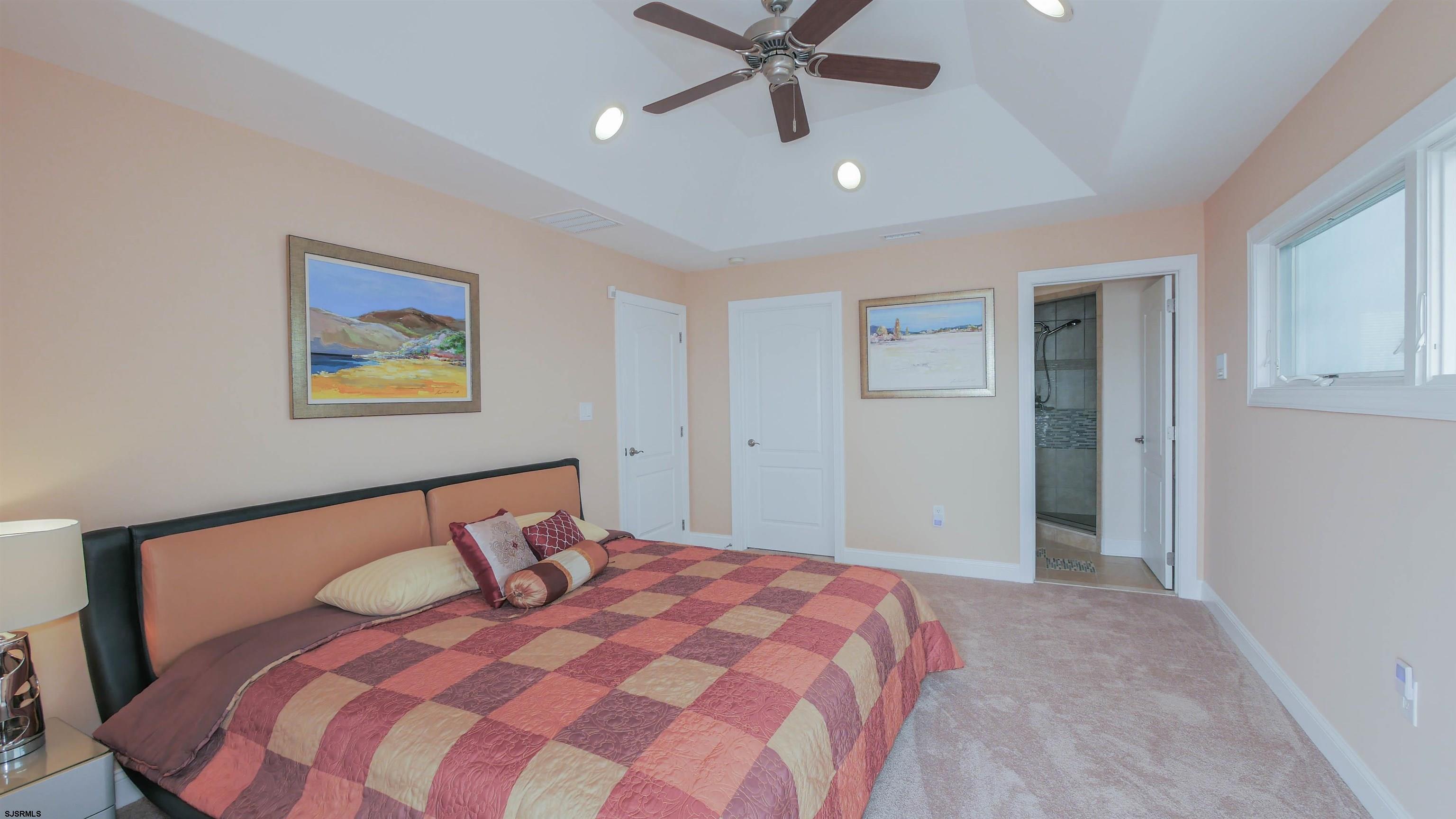 229 8th Street North Brigantine, NJ 08203 - Photo 31 of 42 a bedroom with a bed and a painting on the wall