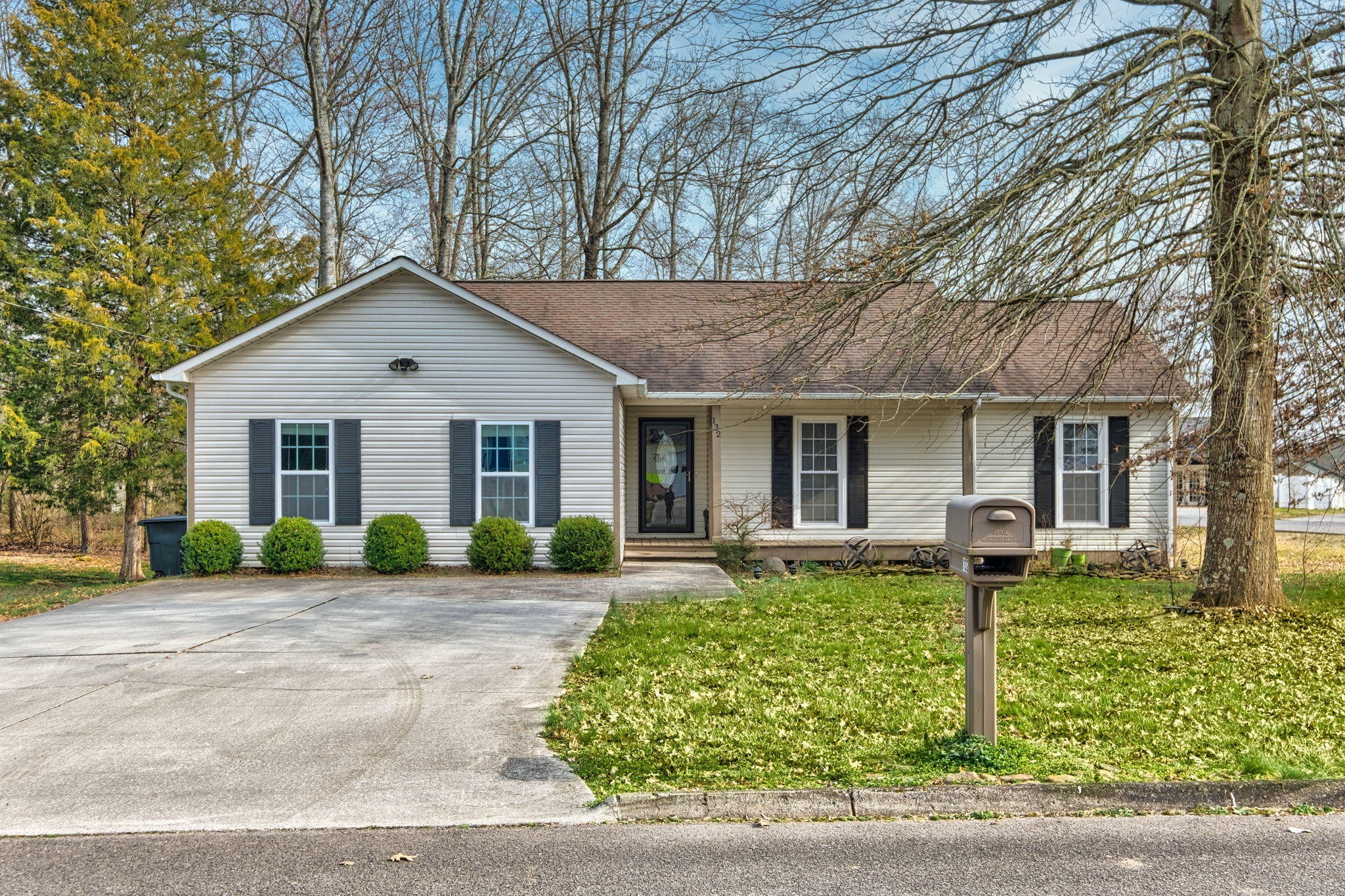 a front view of a house with a yard and porch