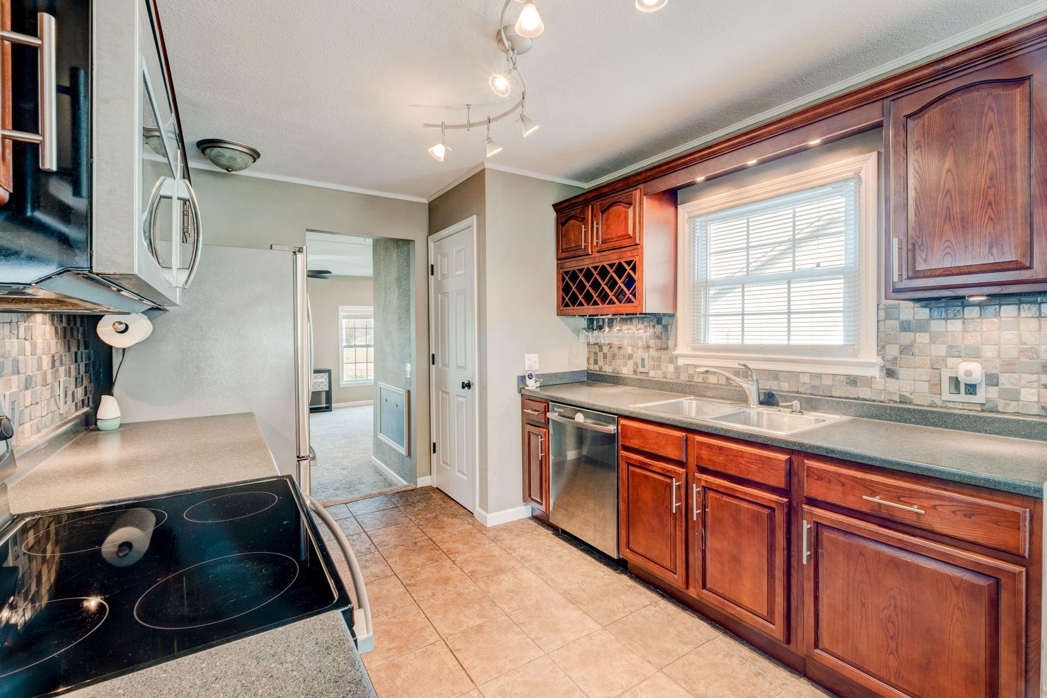 132 Pheasant Road Clinton, TN 37716 - Photo 13 of 40 a large kitchen with stainless steel appliances granite countertop a sink stove and refrigerator