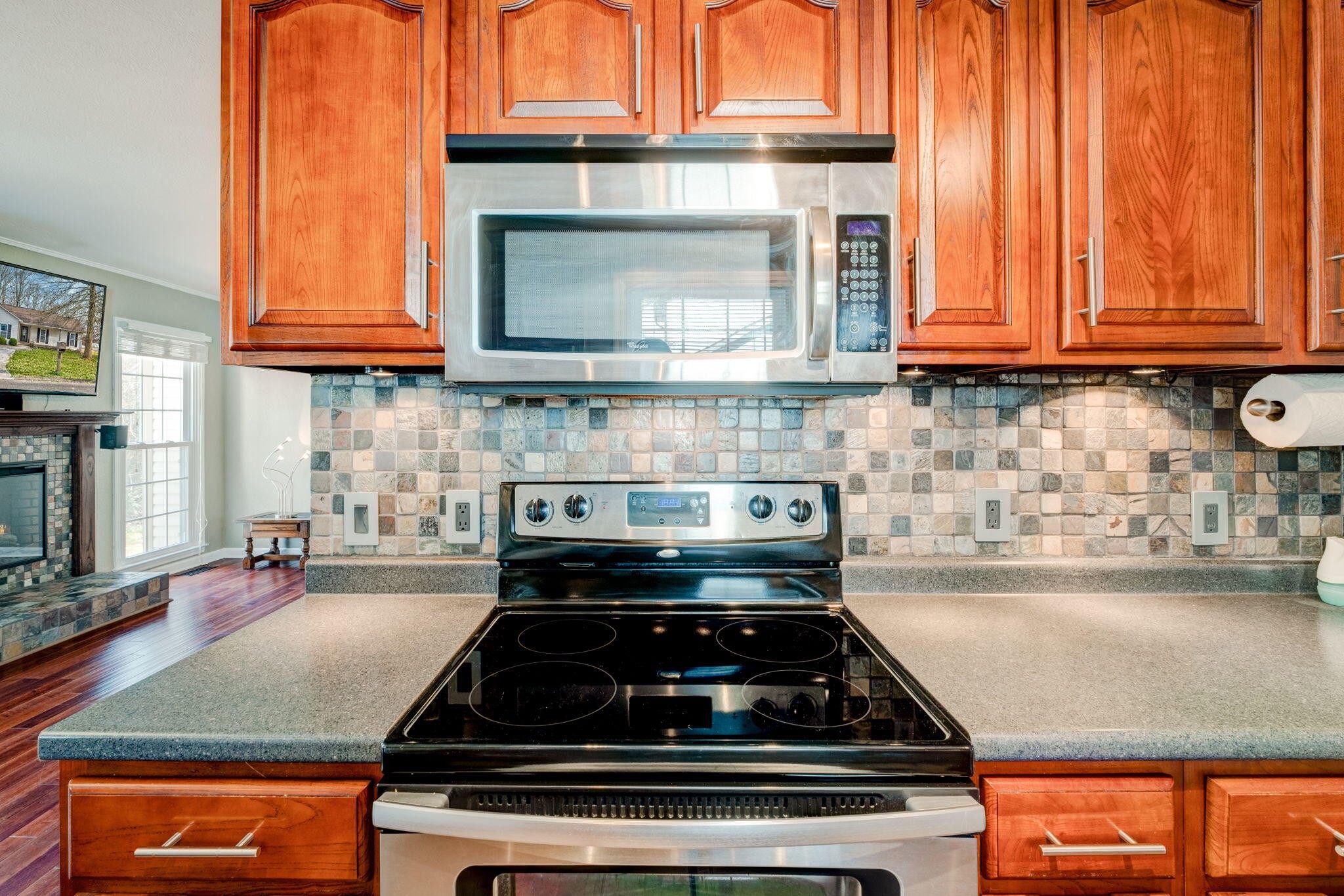 132 Pheasant Road Clinton, TN 37716 - Photo 14 of 40 a kitchen with granite countertop a stove a sink and a microwave