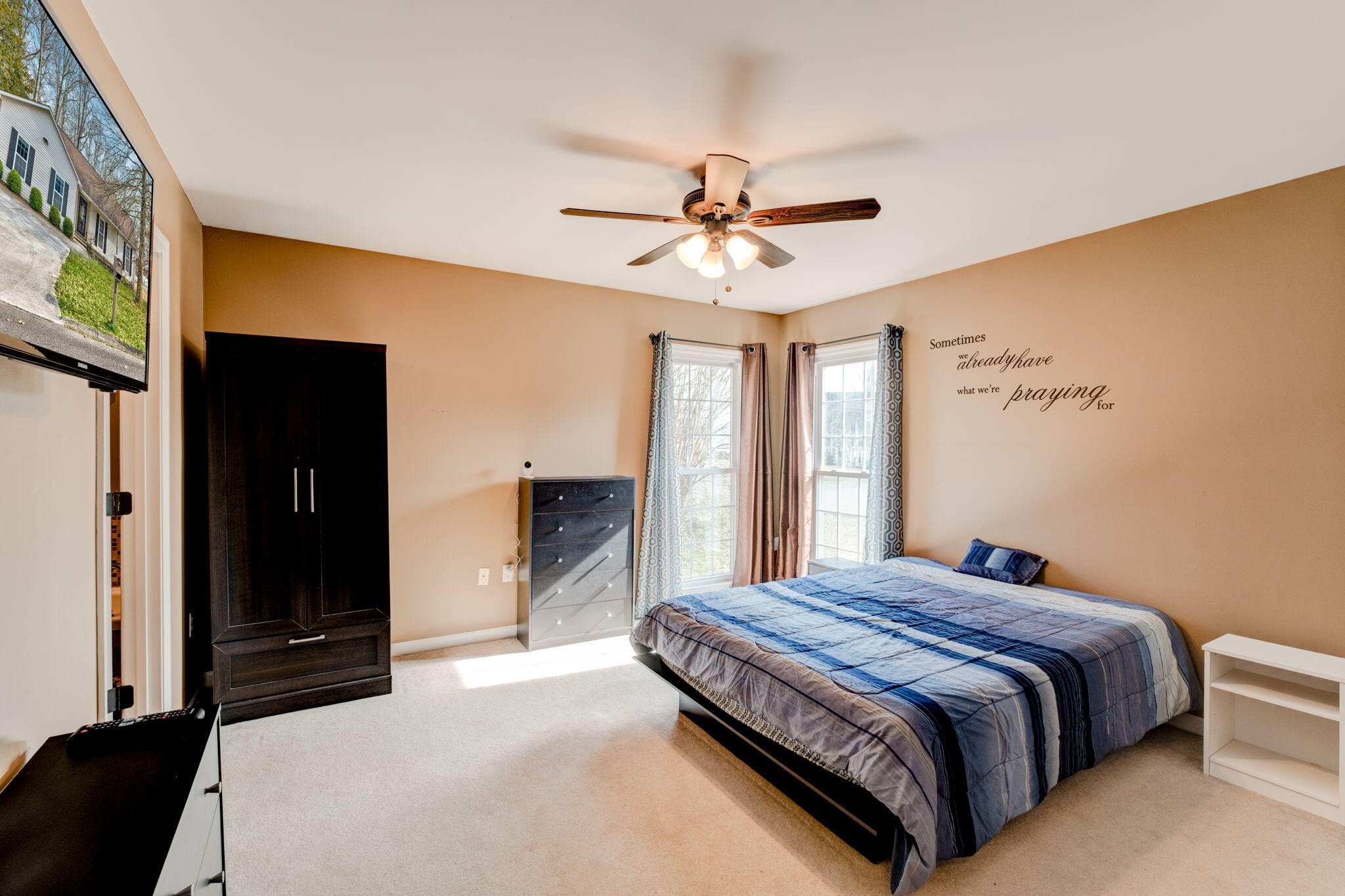 132 Pheasant Road Clinton, TN 37716 - Photo 29 of 40 a bedroom with a large bed and a chandelier
