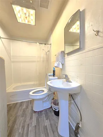 a bathroom with a sink a toilet and a mirror