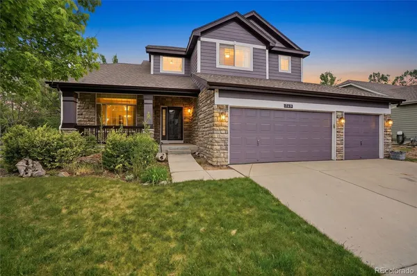 a front view of a house with a yard and garage
