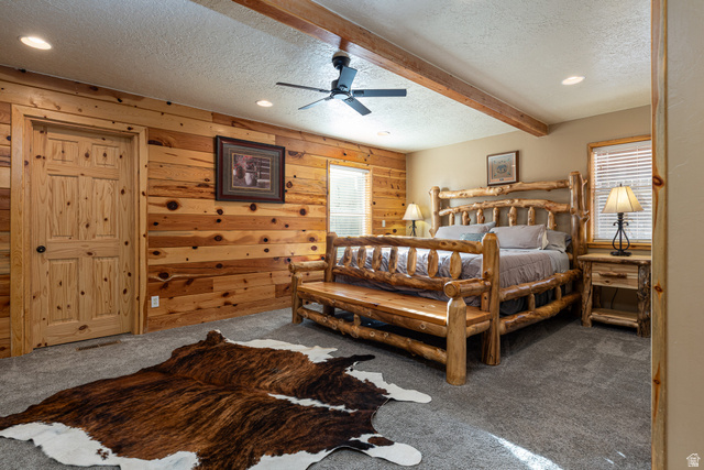 1505 West Elk Ridge Drive Alton, UT 84710 - Photo 16 of 53 Carpeted bedroom with wood walls, a textured ceiling, beamed ceiling, recessed lighting, and a ceiling fan