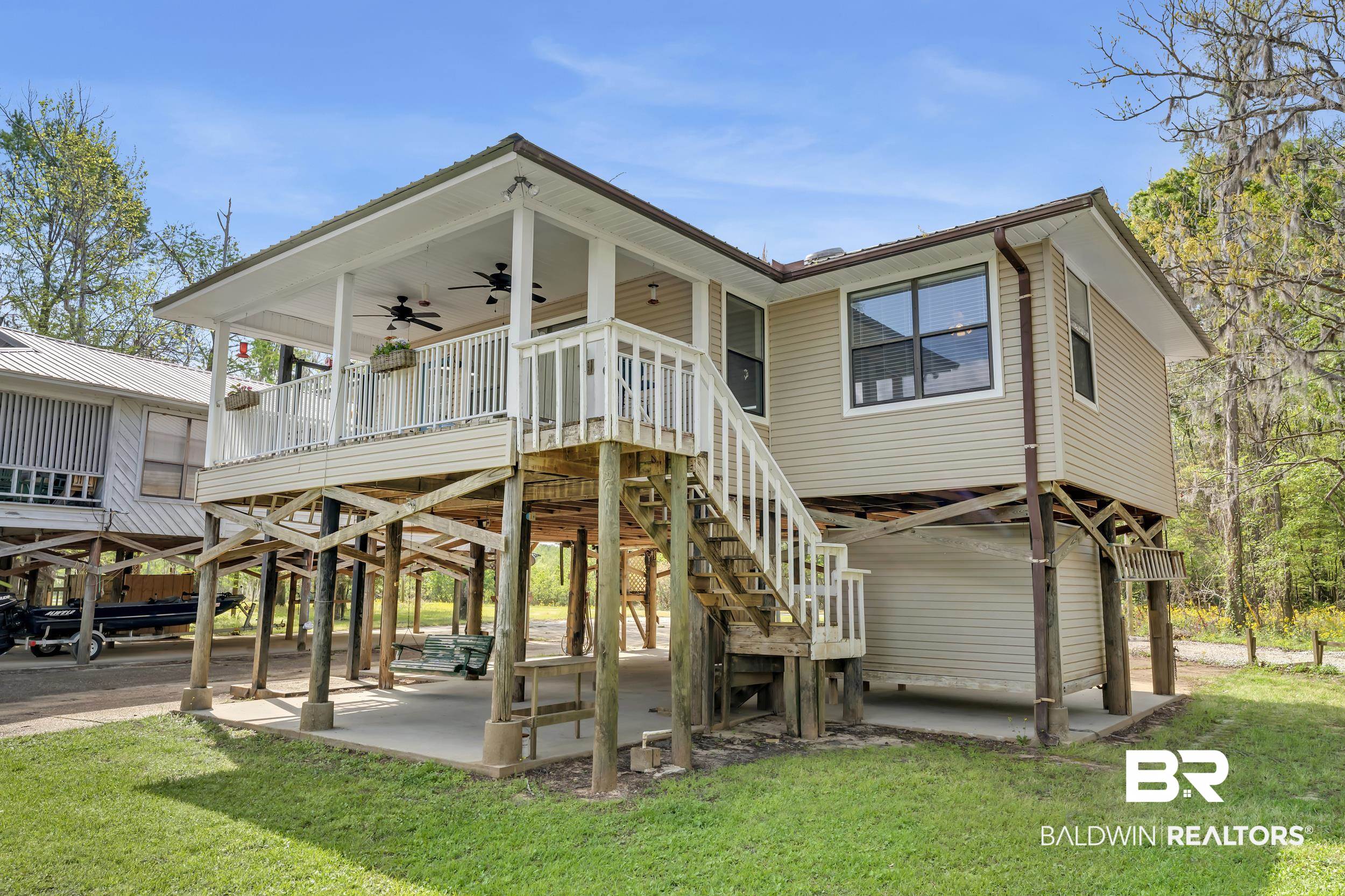 8081 Bryant's Lndg Road Stockton, AL 36579 - Photo 12 of 48 Back of house featuring ceiling fan, a lawn, and a deck