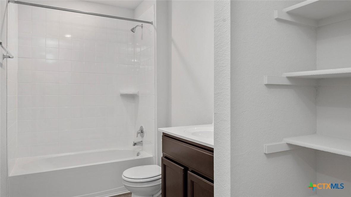 112 Little Green Trail Jarrell, TX 76537 - Photo 21 of 22 a bathroom with a shower a toilet and a sink