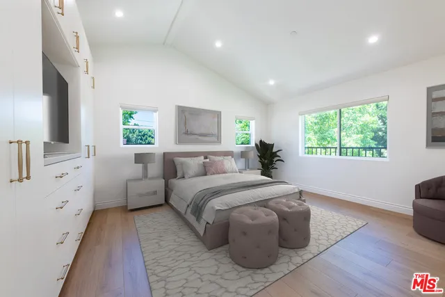 a spacious bedroom with a large bed and a window