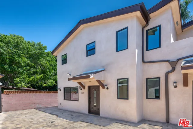 a front view of a house with trees