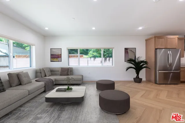 a living room with furniture rug and window