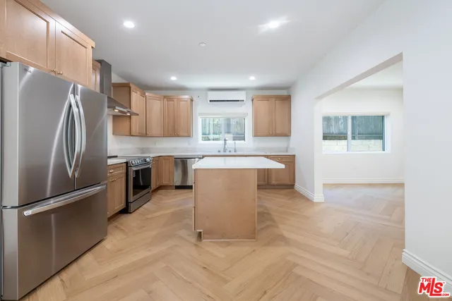 a kitchen with stainless steel appliances granite countertop a refrigerator sink and cabinets