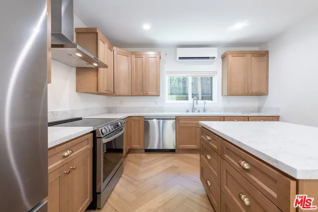 a kitchen with stainless steel appliances granite countertop a sink stove and cabinets