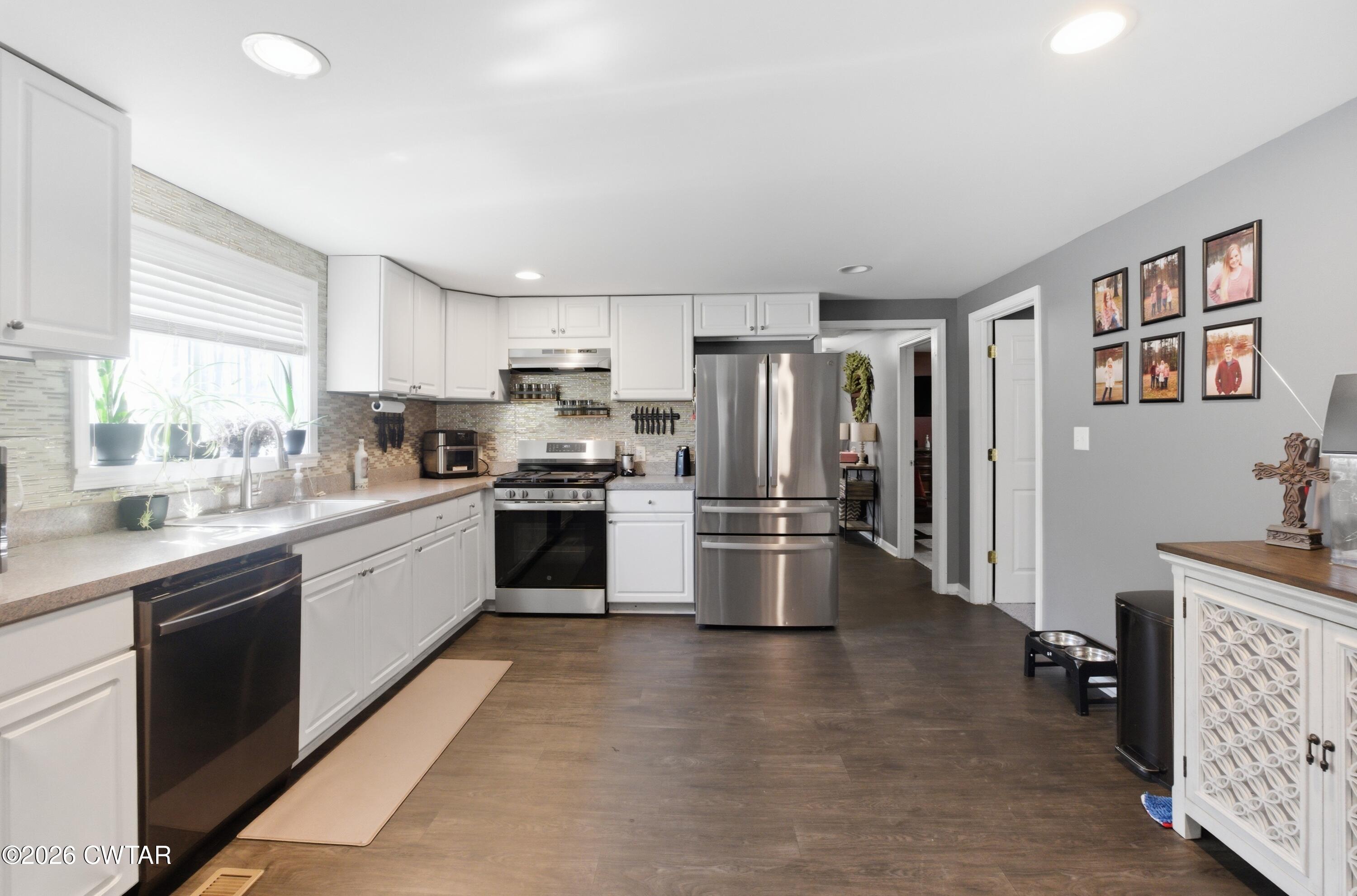 390 Memory Lane Henderson, TN 38340 - Photo 12 of 24 a kitchen with stainless steel appliances a refrigerator sink and microwave