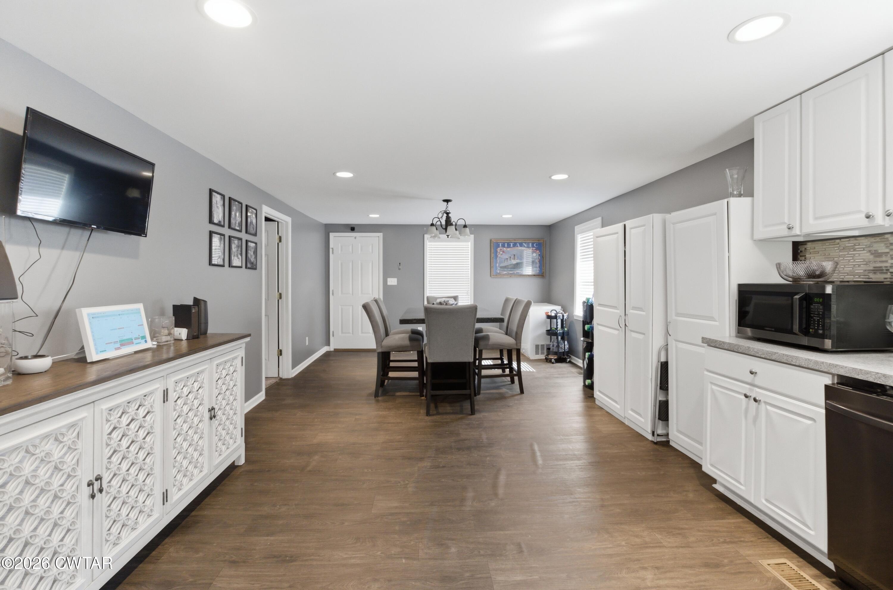390 Memory Lane Henderson, TN 38340 - Photo 14 of 24 a living room with furniture a flat screen tv and kitchen view