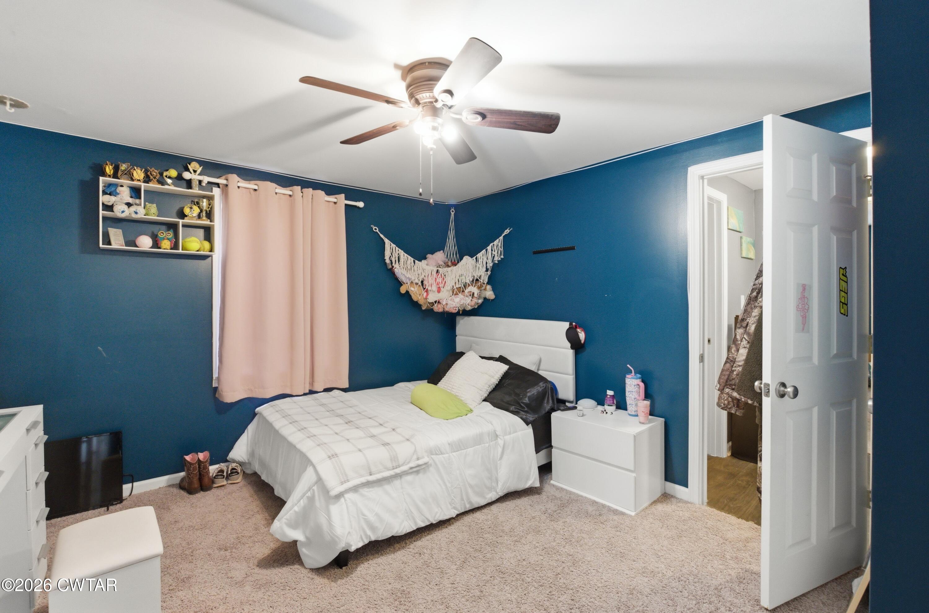 390 Memory Lane Henderson, TN 38340 - Photo 17 of 24 a bed room with a bed and a chandelier