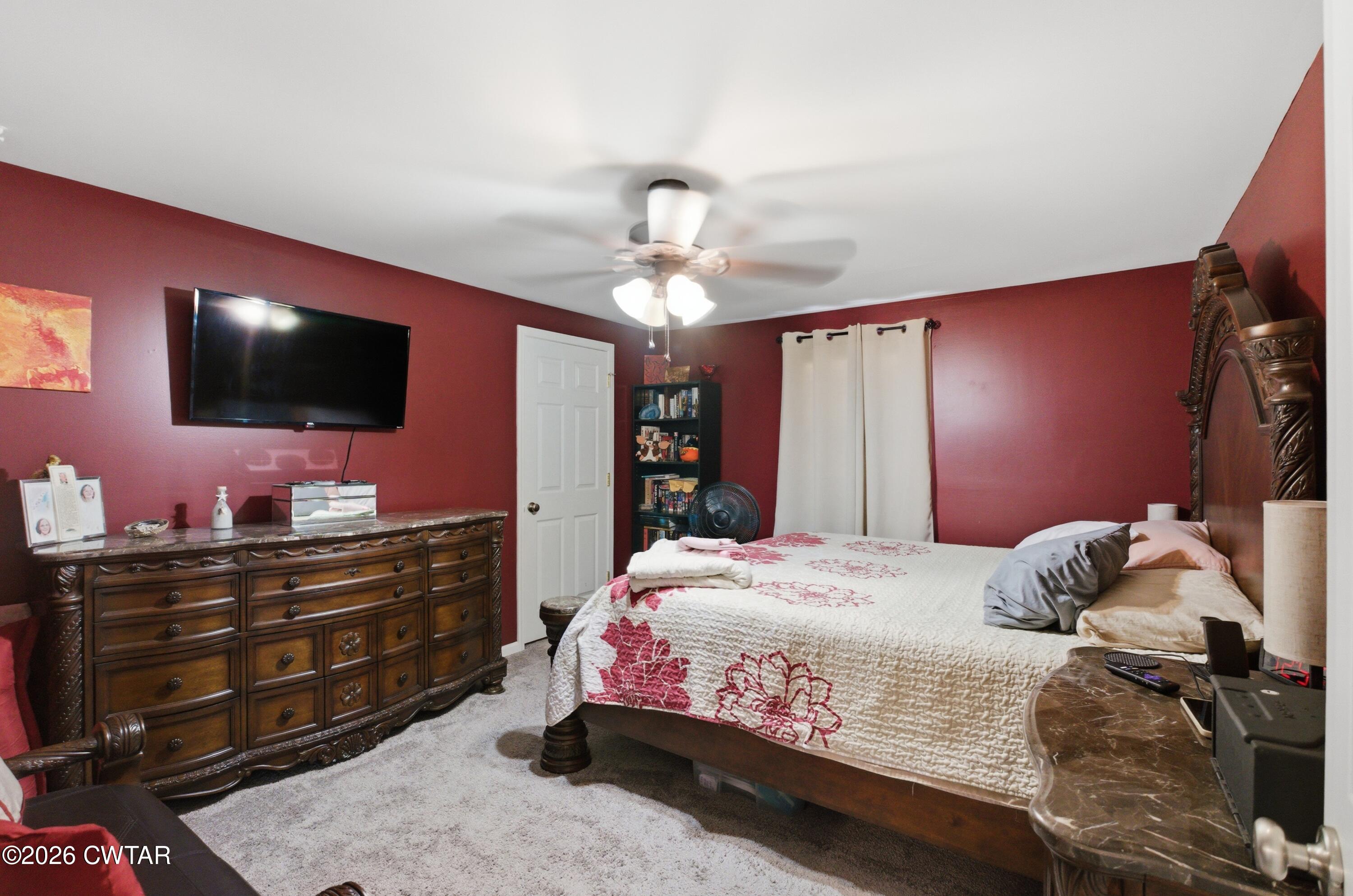 390 Memory Lane Henderson, TN 38340 - Photo 19 of 24 a bedroom with a bed and a flat screen tv
