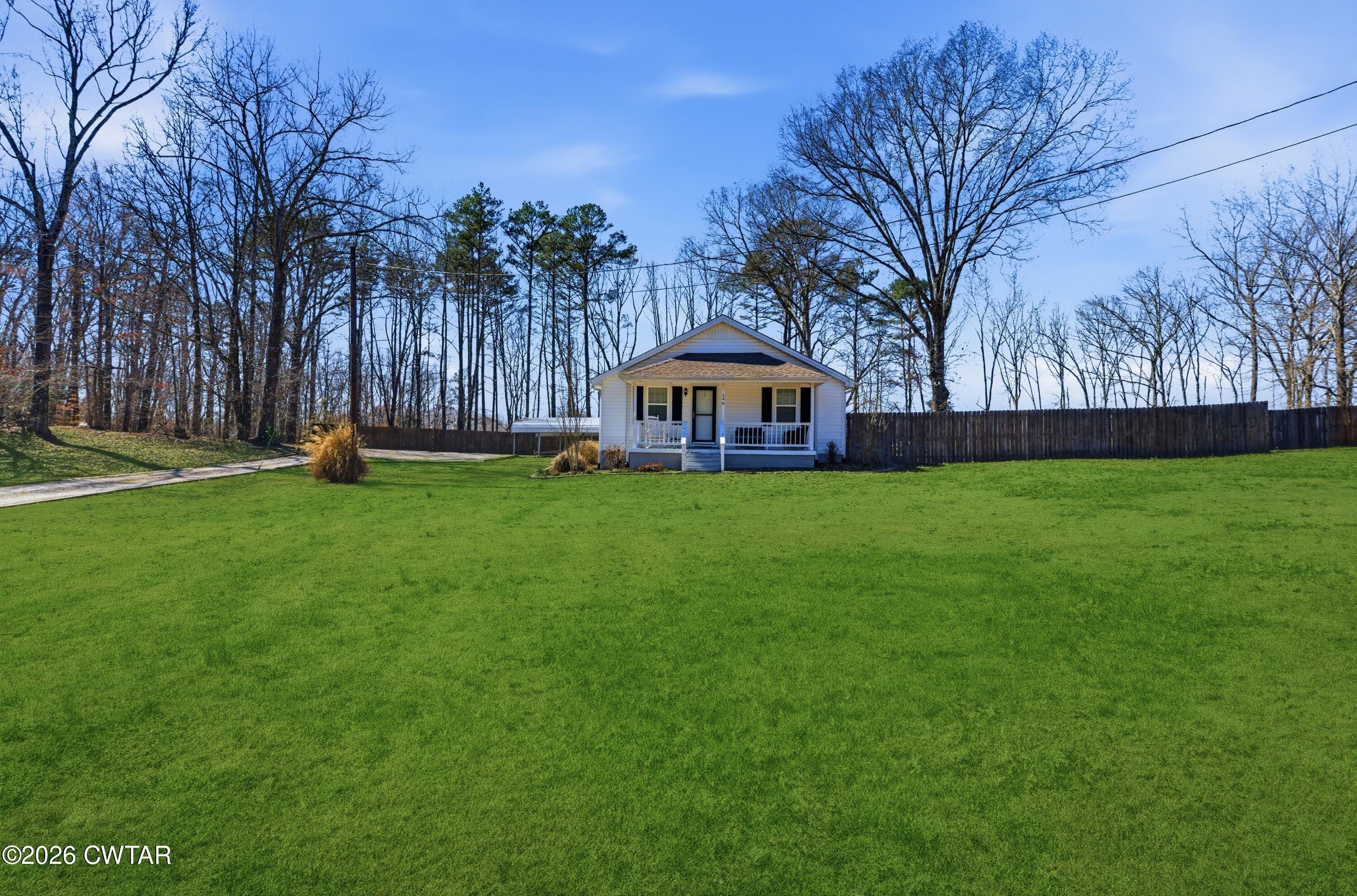 390 Memory Lane Henderson, TN 38340 - Photo 2 of 24 a view of a house with garden and trees
