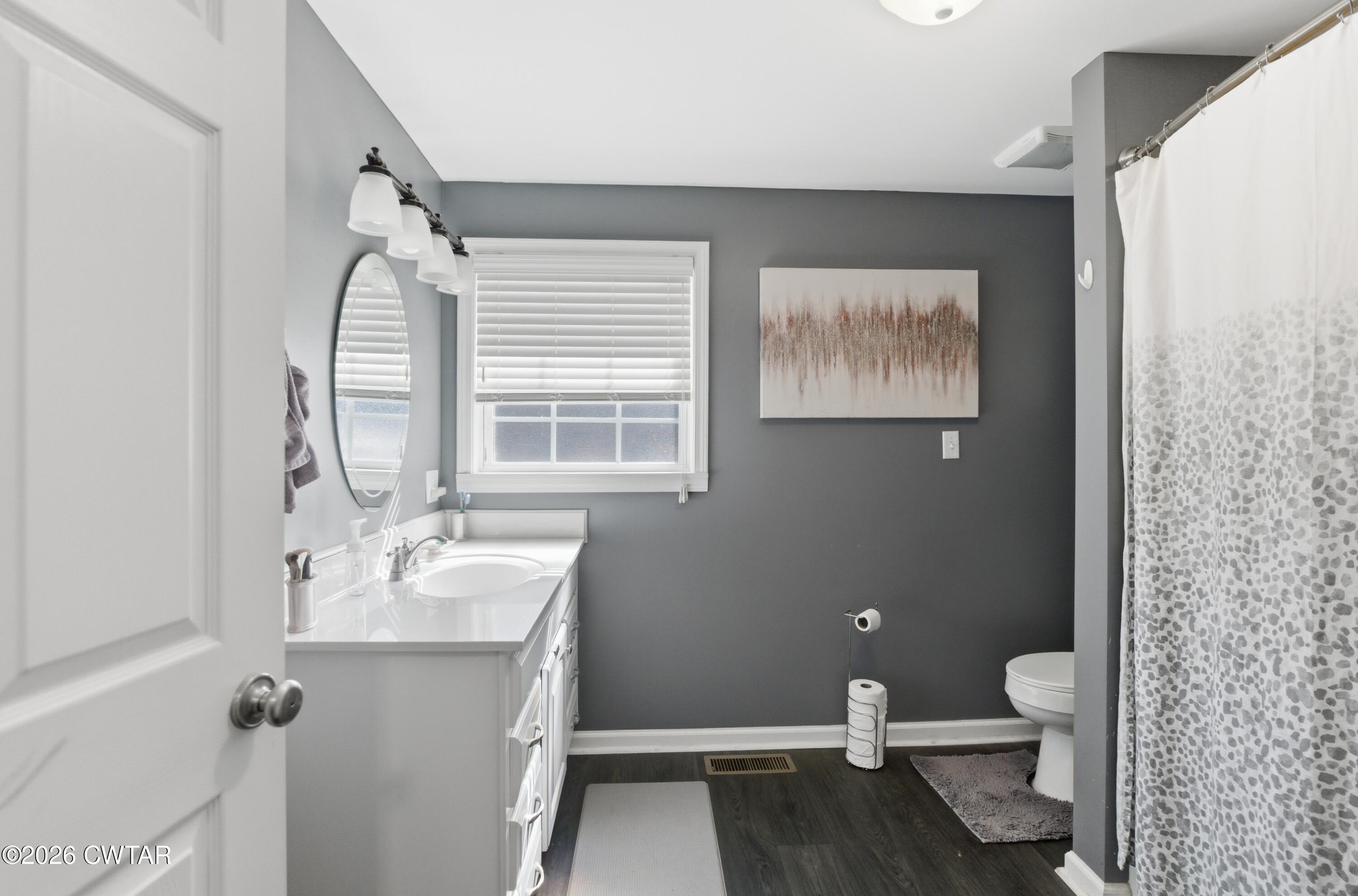 390 Memory Lane Henderson, TN 38340 - Photo 21 of 24 a bathroom with a granite countertop sink toilet and shower