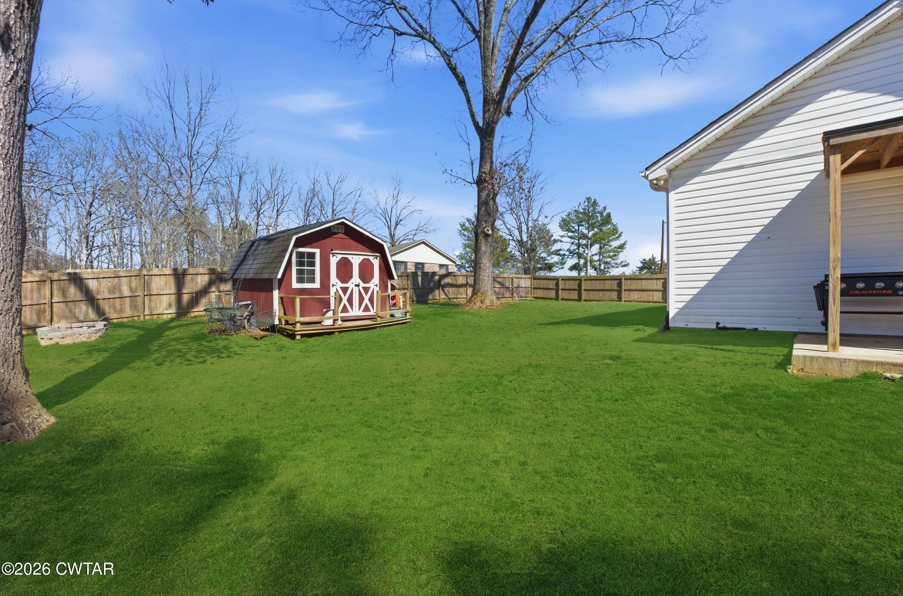 390 Memory Lane Henderson, TN 38340 - Photo 5 of 24 a view of a house with a big yard and large trees