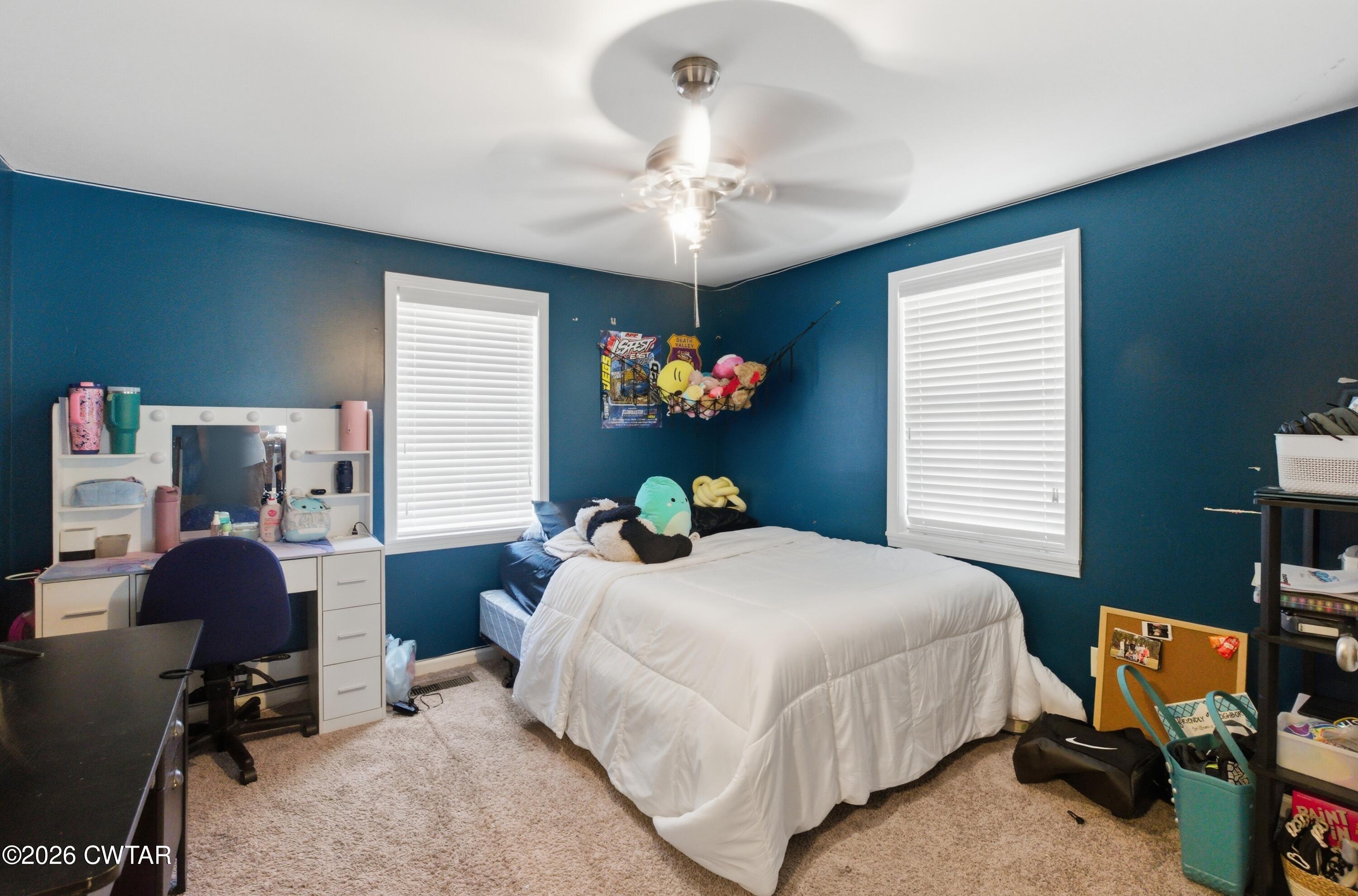 390 Memory Lane Henderson, TN 38340 - Photo 9 of 24 a bedroom with a bed and a chandelier