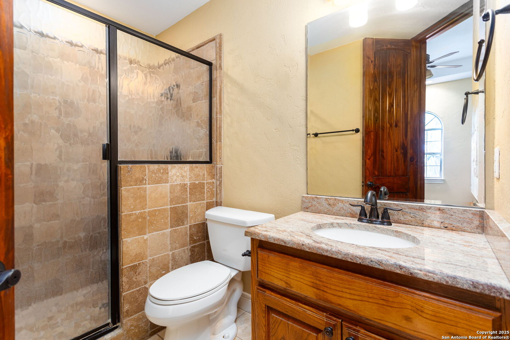 192 County Road 2812 Mico, TX 78056 - Photo 25 of 47 a bathroom with a granite countertop sink toilet and shower