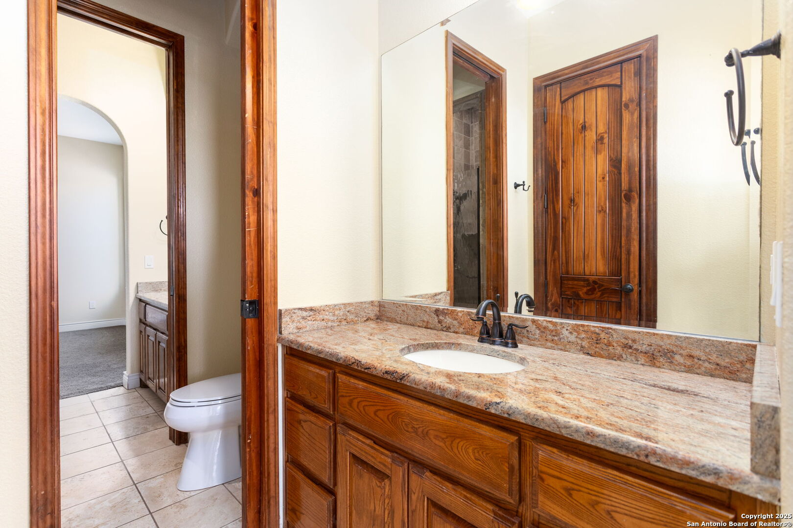 192 County Road 2812 Mico, TX 78056 - Photo 27 of 47 a bathroom with a granite countertop sink toilet and shower