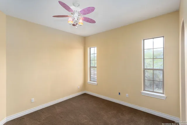 an empty room with windows and closet