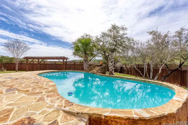 a view of swimming pool with a lounge chair