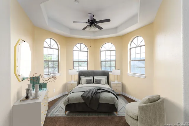 a bedroom with a bed and dresser with mirror