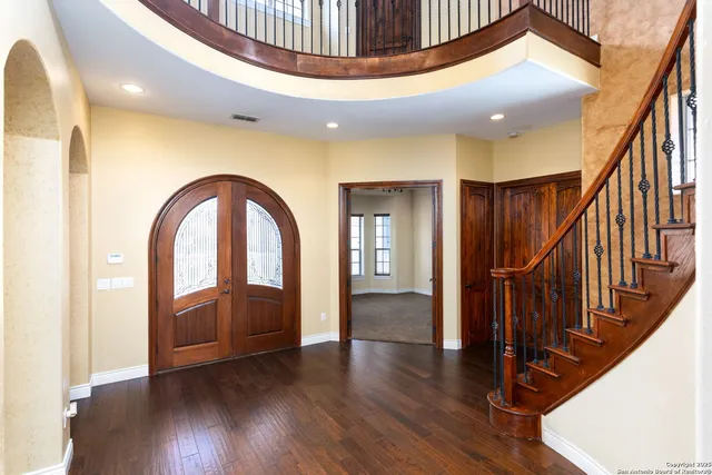 a view of entryway with wooden floor and stairs