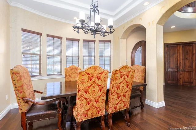 a view of a dining room with furniture and chandelier
