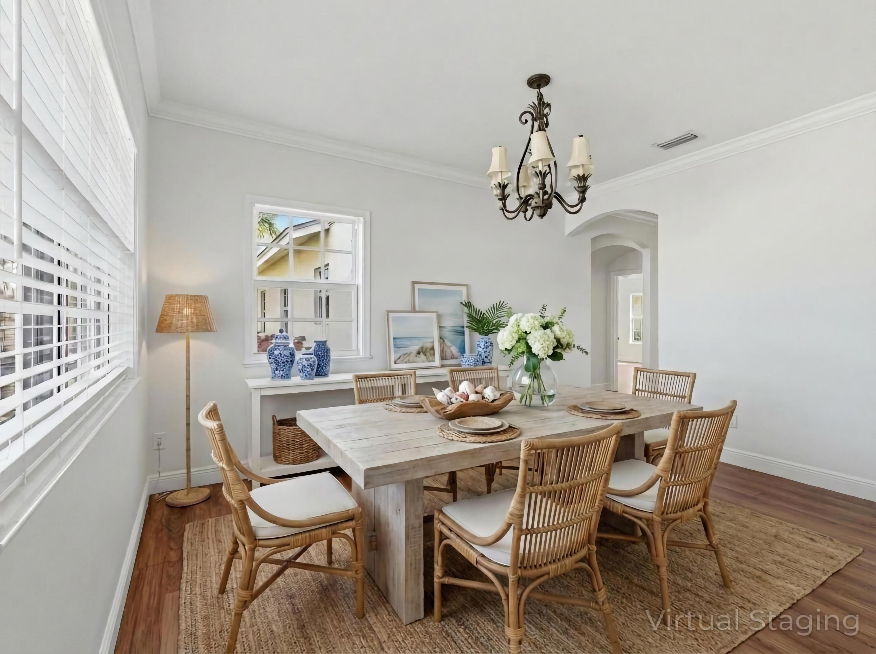 9322 Southeast Athena Street Hobe Sound, FL 33455 - Photo 17 of 68 a dining room with furniture a chandelier and wooden floor